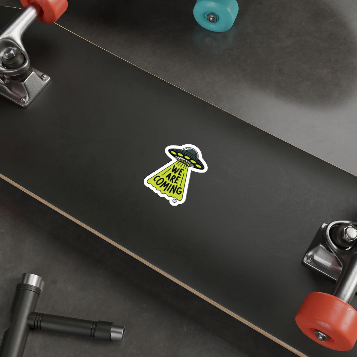 Skateboard with We Are Coming Alien Sticker Deck