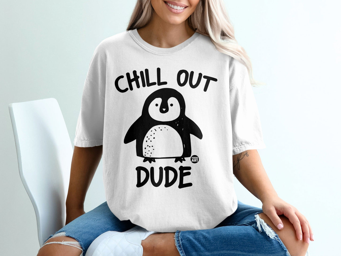 White t-shirt with "CHILL OUT DUDE" and a penguin graphic.