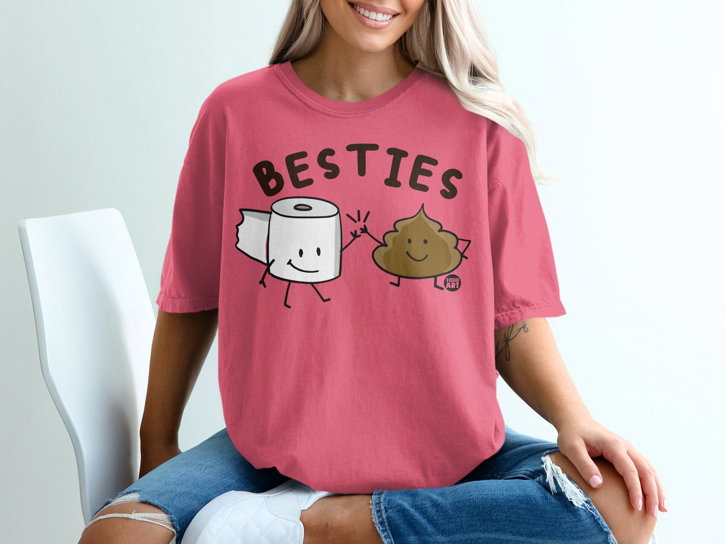 Pink t-shirt with "BESTIES" text, featuring cartoon toilet paper and poop characters.