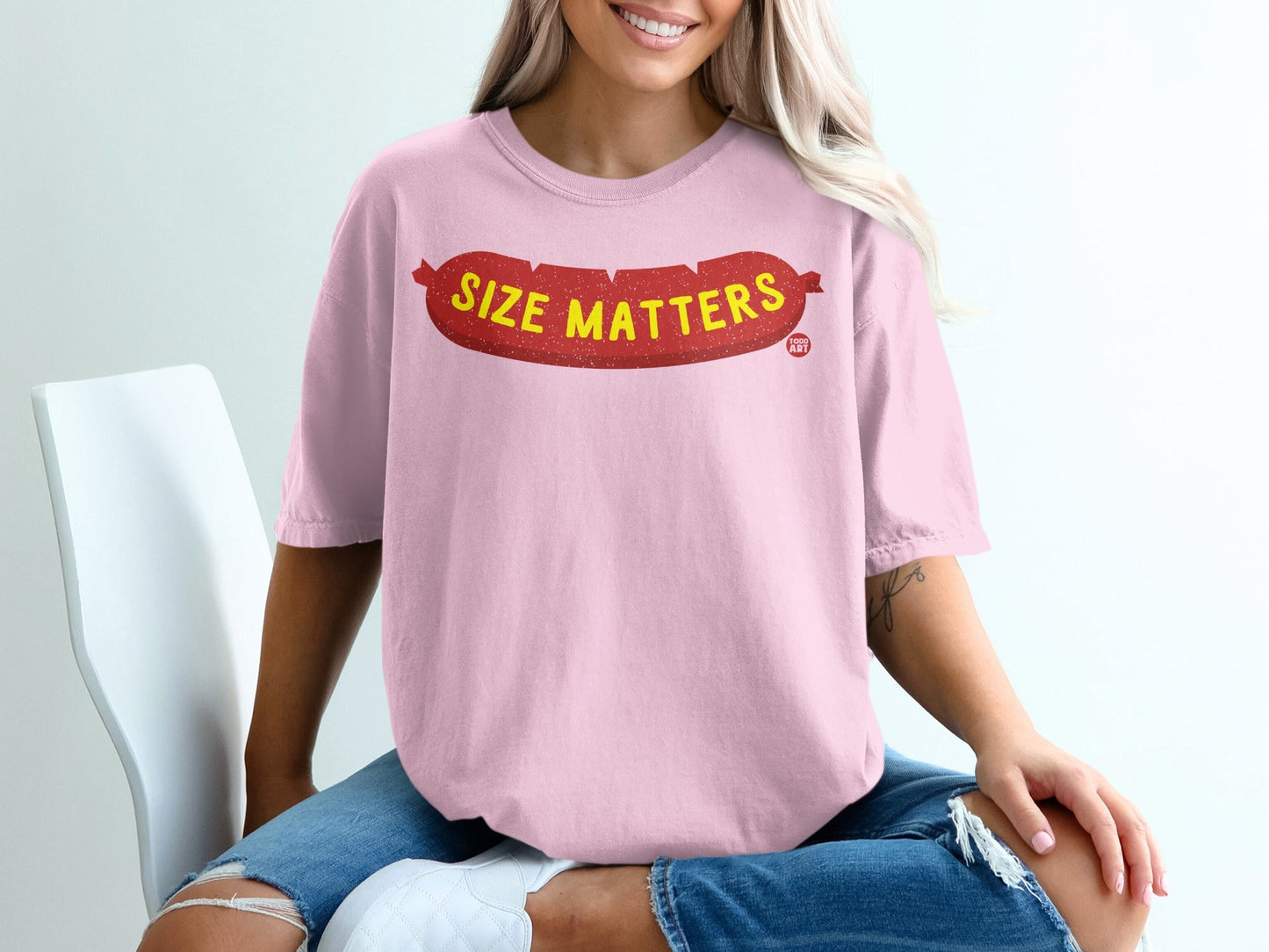 Pink t-shirt with "SIZE MATTERS" text in red sausage shape.