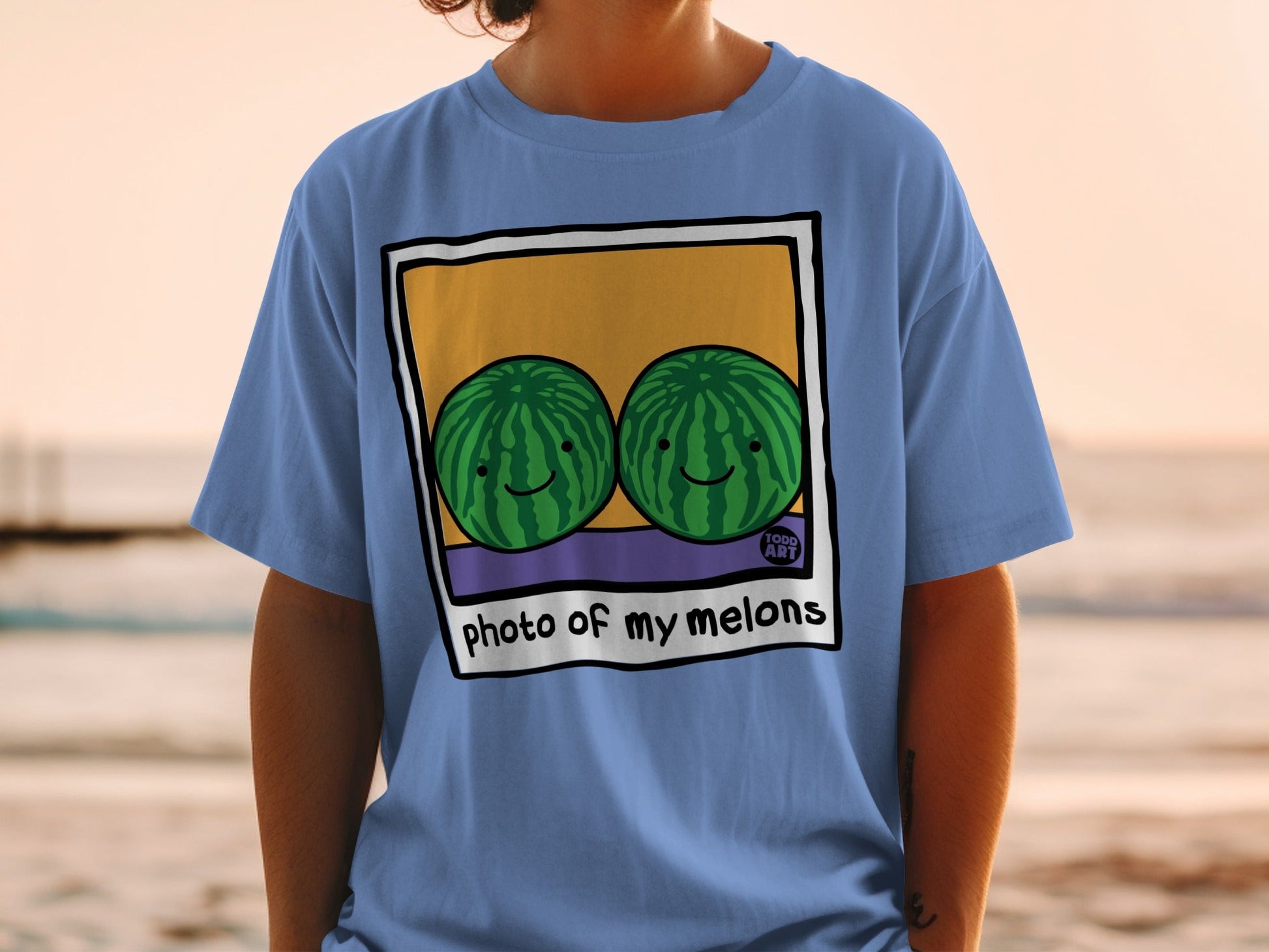Blue t-shirt with two smiling watermelons in a framed image with text.