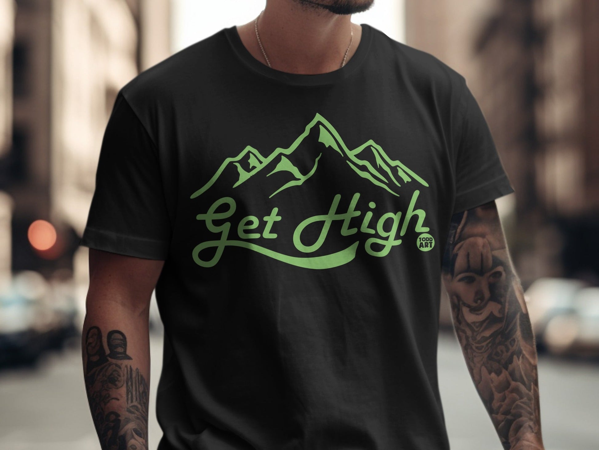 Black t-shirt with green mountain graphic and "Get High Food Art" text.