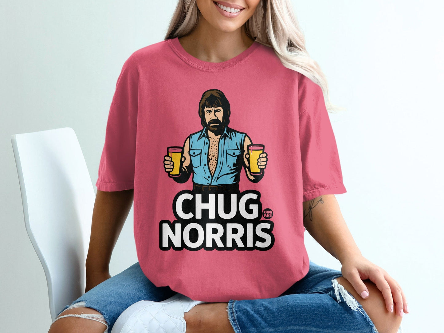 Pink t-shirt with Chuck Norris holding two beers and text "CHUG NORRIS".