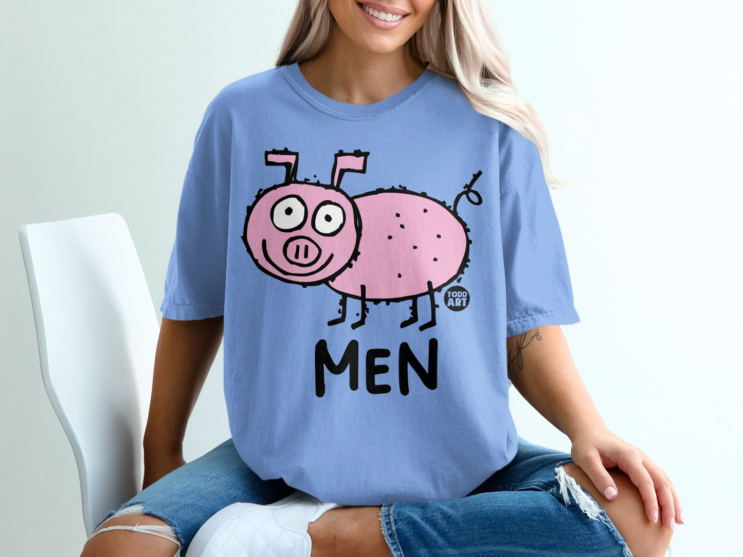 Blue t-shirt with a cartoon pig and text that reads "MEN".