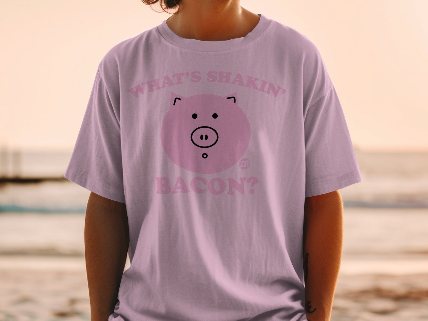 Pink t-shirt with a cartoon pig face and "What's shakin' bacon?" text.