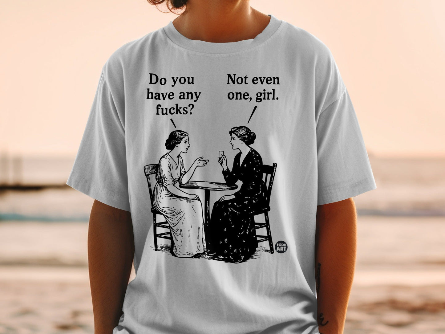 Two women sit at a table, one asking "Do you have any fucks?".