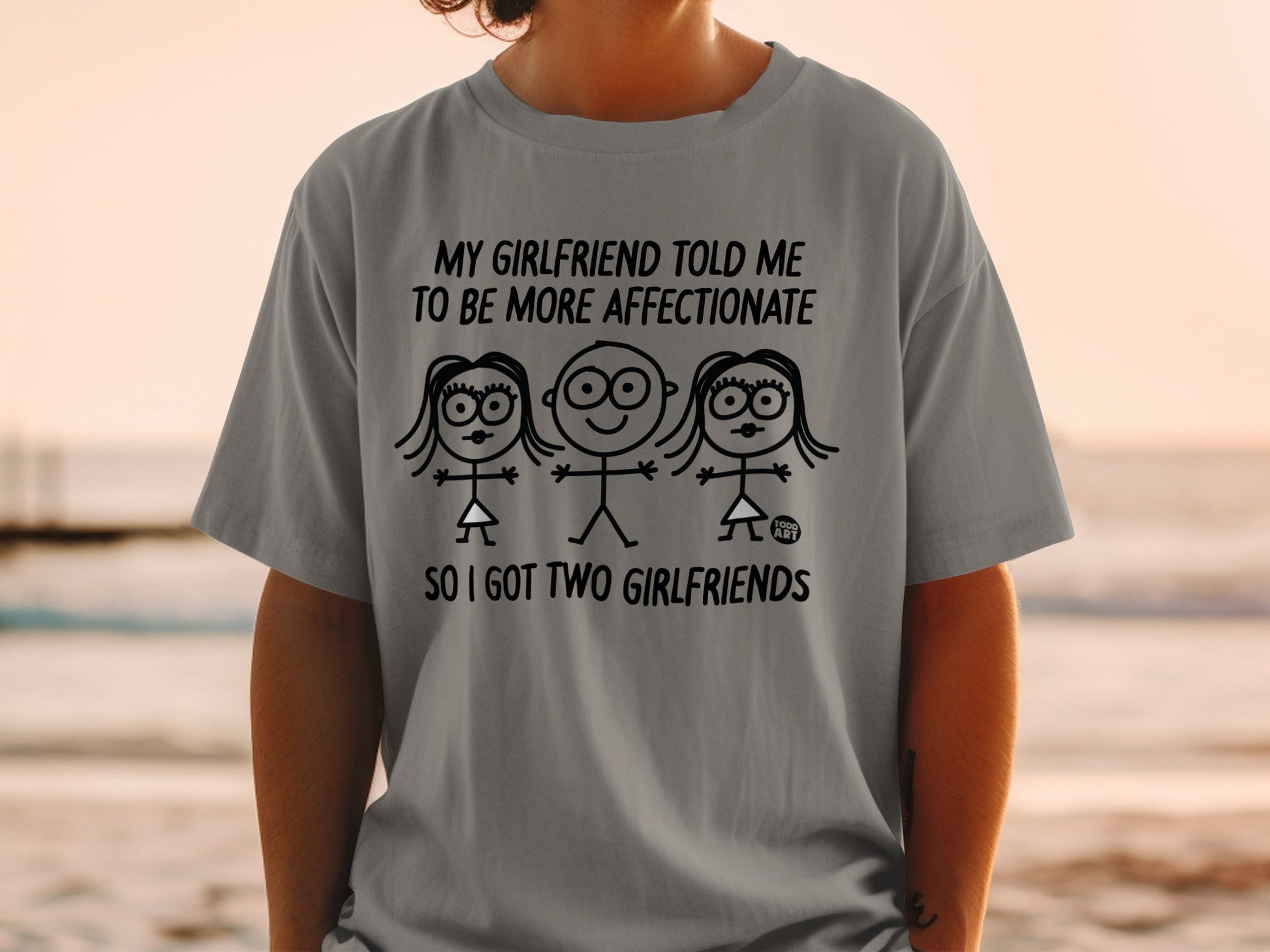 Gray t-shirt with text "My girlfriend told me to be more affectionate so I got two girlfriends."