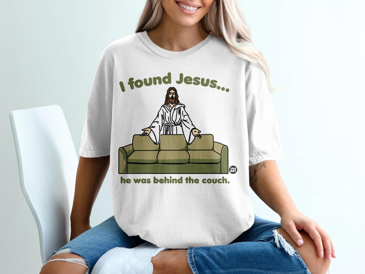 T-shirt with text "I found Jesus... he was behind the couch."