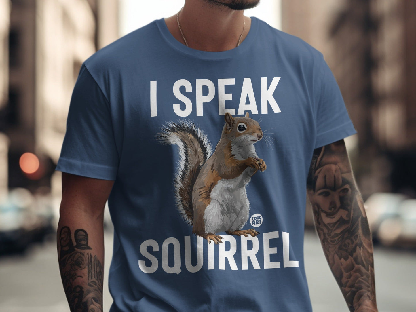 Blue t-shirt with "I SPEAK SQUIRREL" text and a squirrel graphic.
