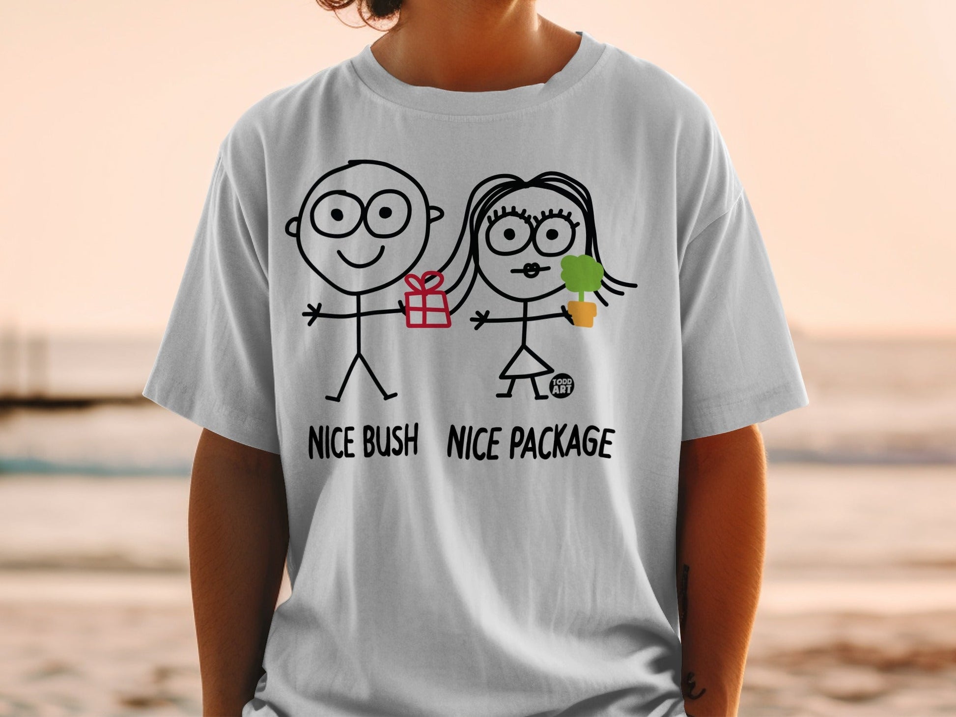 White t-shirt with stick figures giving a gift and plant, text "NICE BUSH NICE PACKAGE".