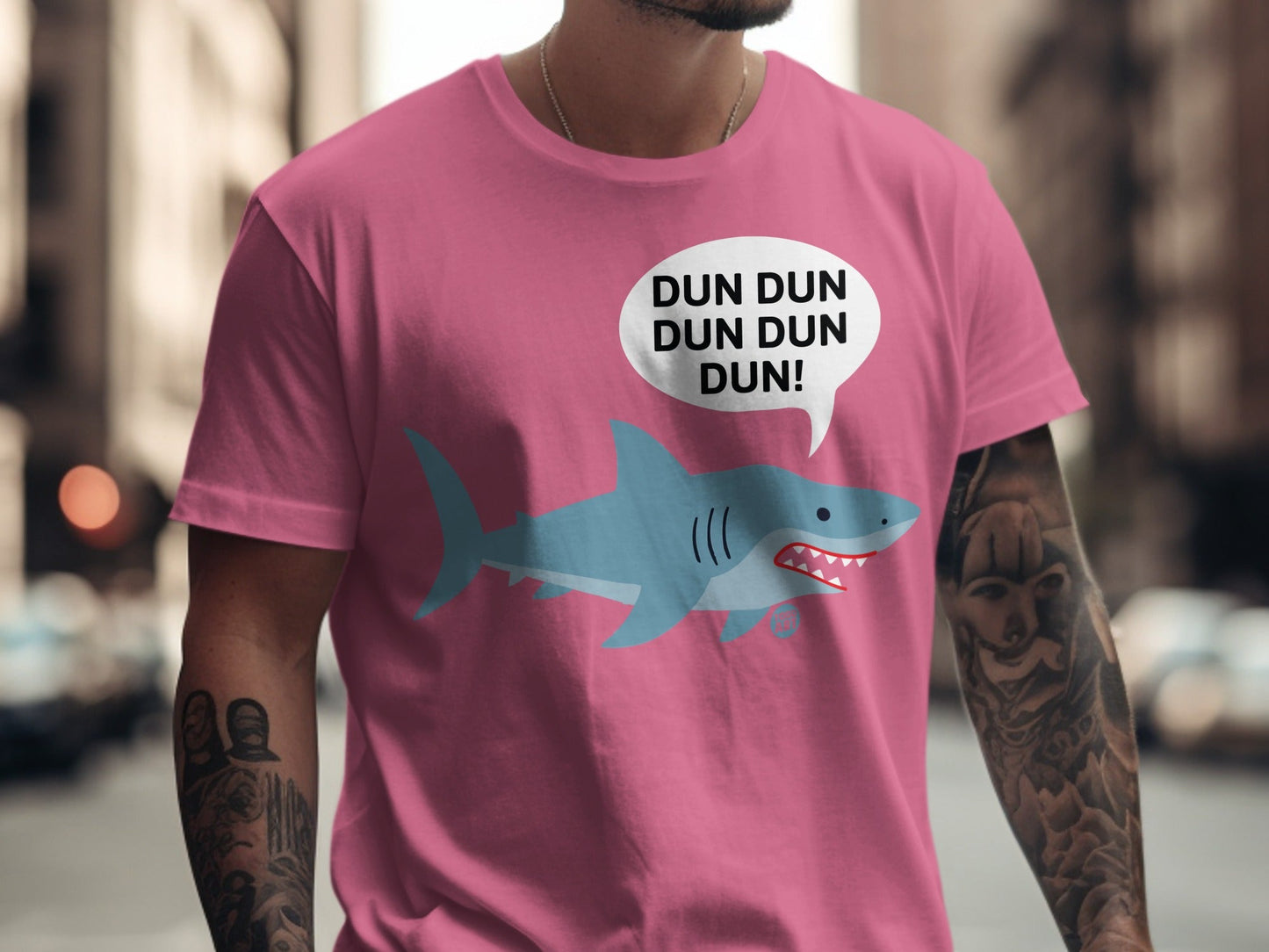 Pink t-shirt with a cartoon shark and "DUN DUN DUN DUN!" speech bubble.