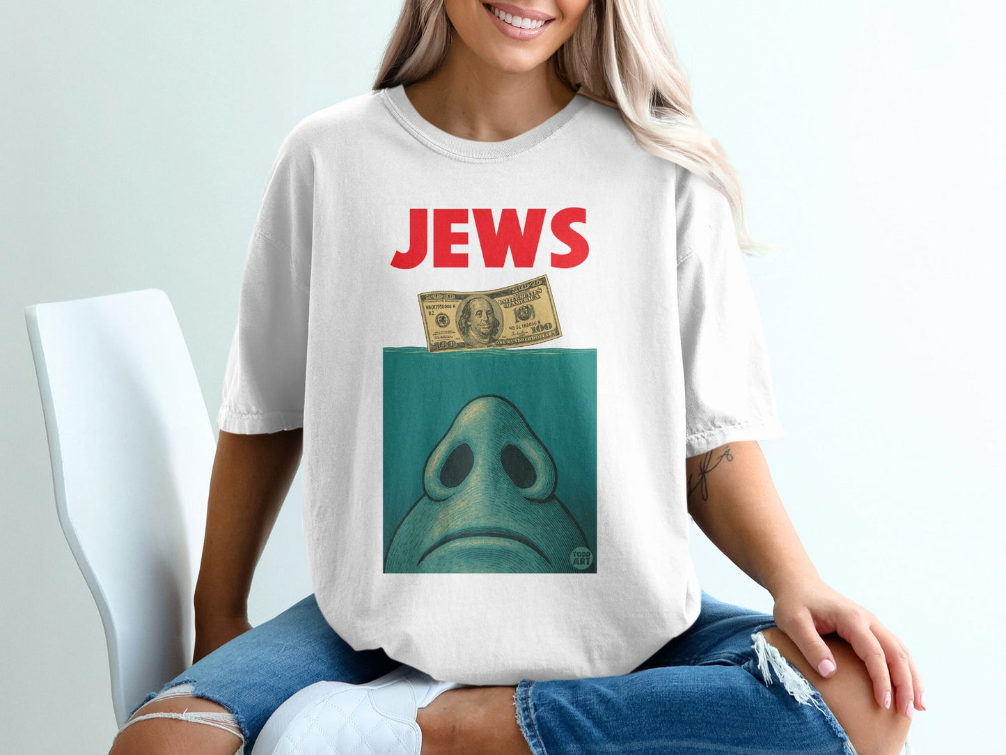 T-shirt with "JEWS" in red text over a drawing of a shark's eye and a dollar bill.
