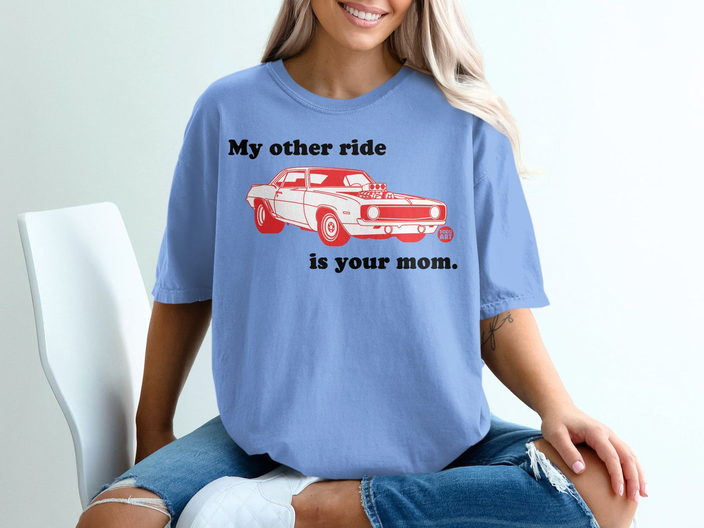 Blue t-shirt with a red graphic of a vintage car and text.