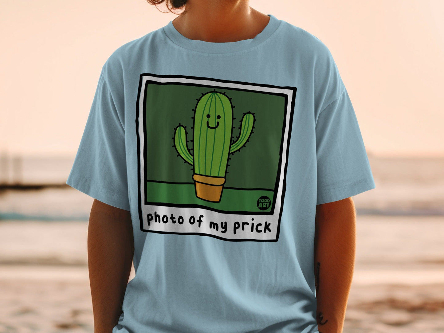 T-shirt featuring a smiling cartoon cactus in a pot, with "photo of my prick" text.