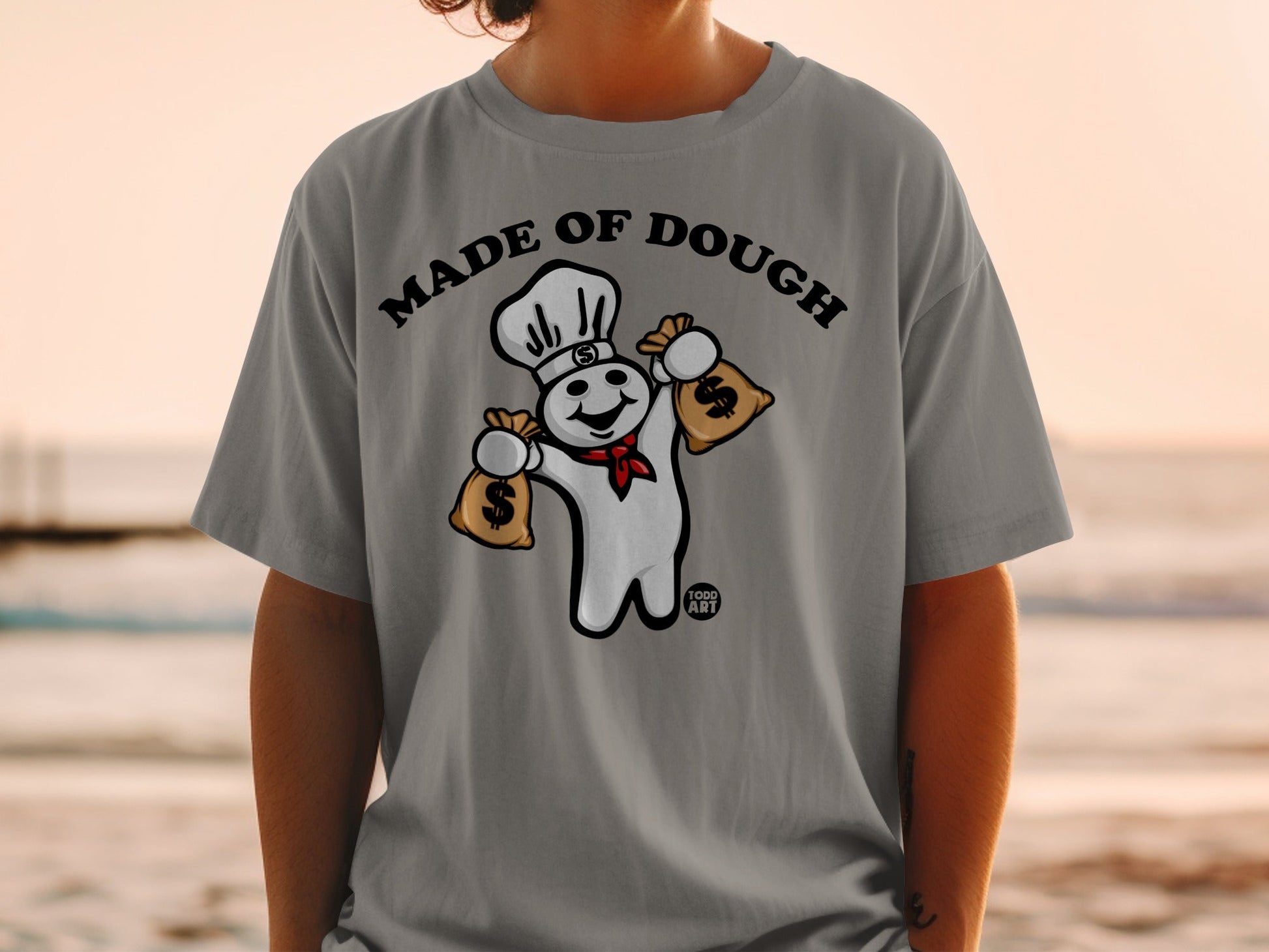 Pillsbury Doughboy with chef hat holding money bags, text "MADE OF DOUGH".