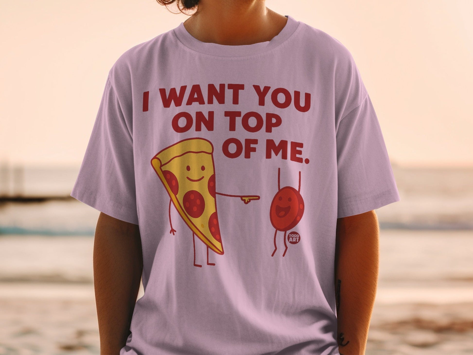 T-shirt with pepperoni pizza slice and blood drop graphic and text "I WANT YOU ON TOP OF ME."