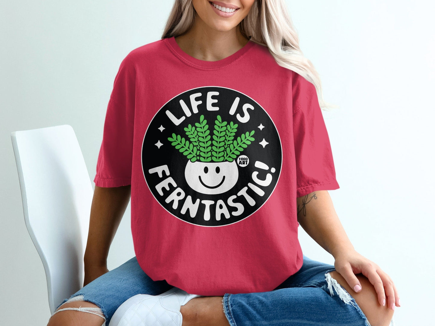 Red t-shirt with "Life is Ferntastic!" text and smiling fern plant graphic.