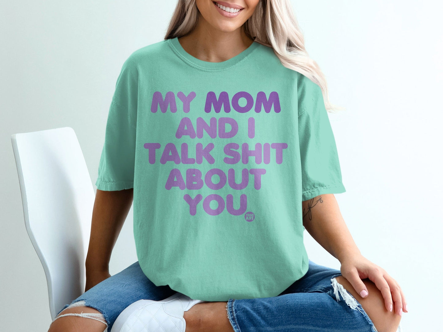 Mint t-shirt with "My Mom and I Talk Shit About You" text in purple.