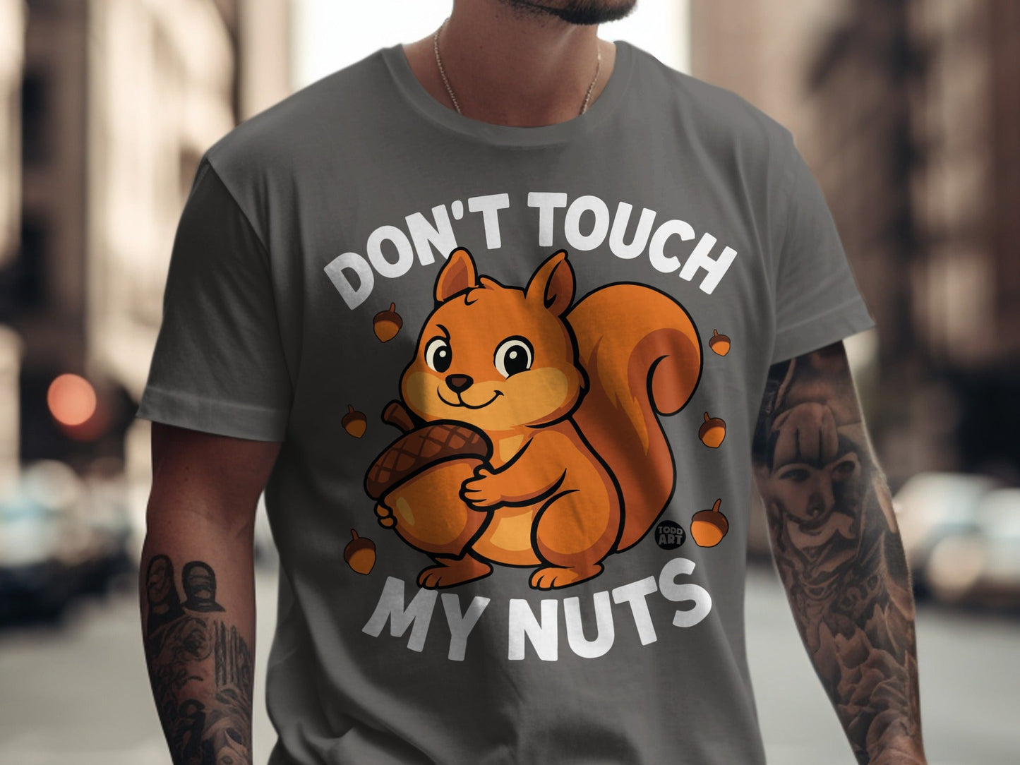 T-shirt with cartoon squirrel holding acorn, text reads "Don't Touch My Nuts."