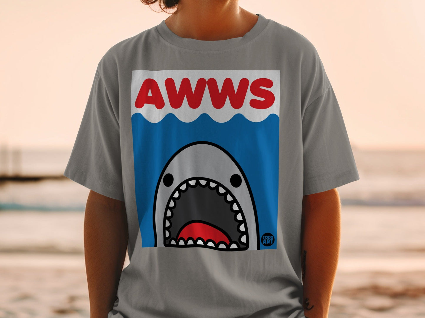 Gray t-shirt with cartoon shark graphic and "AWWS" text.