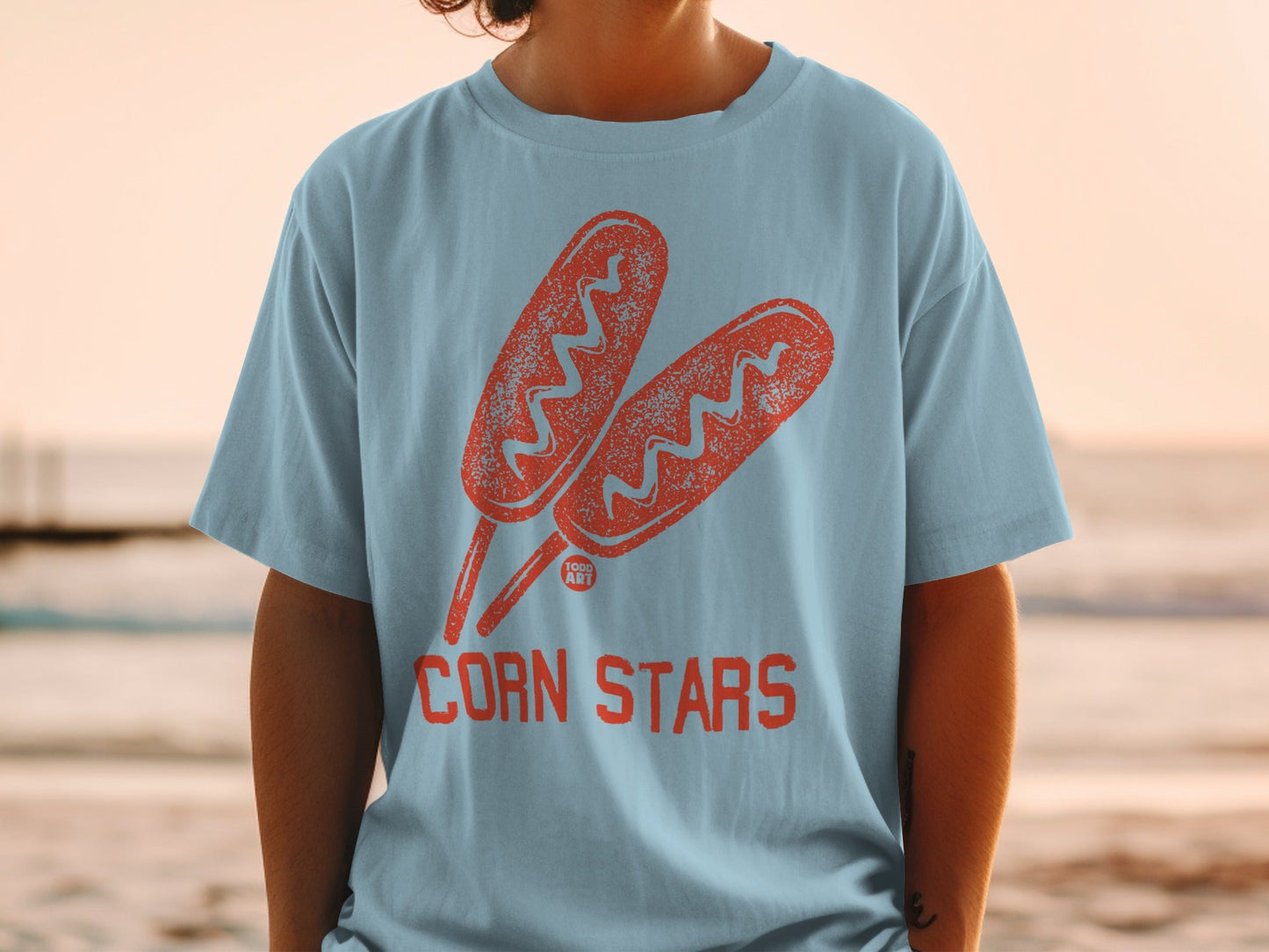 Blue t-shirt with two cartoon corn dogs and "CORN STARS" text.