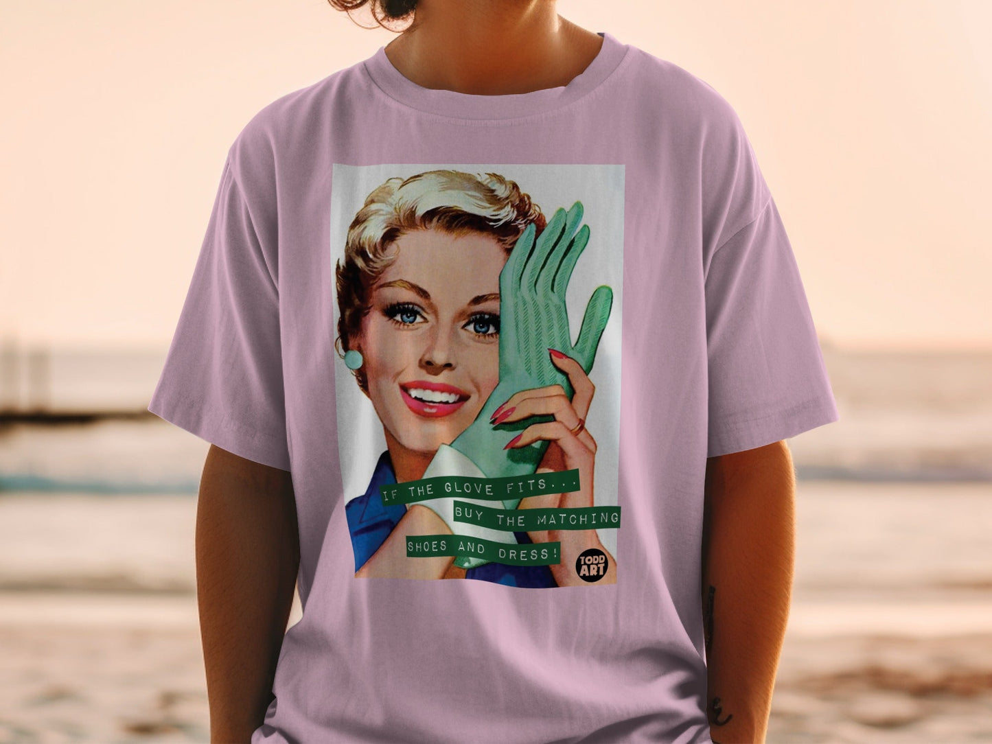 Woman in pink shirt wearing a vintage graphic t-shirt with a retro woman and text.