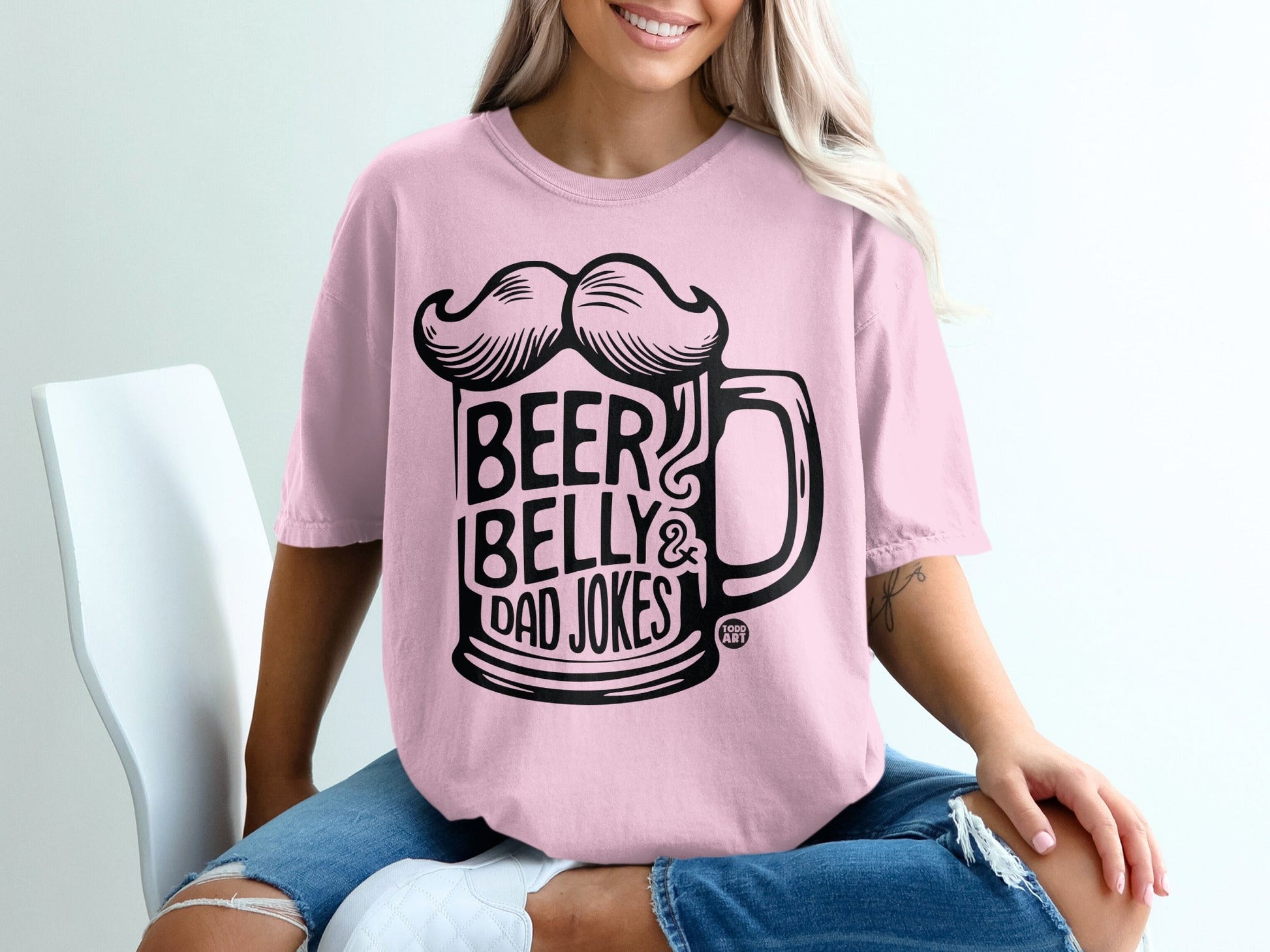 Pink t-shirt with "Beer Belly & Dad Jokes" graphic featuring a beer mug and mustache.