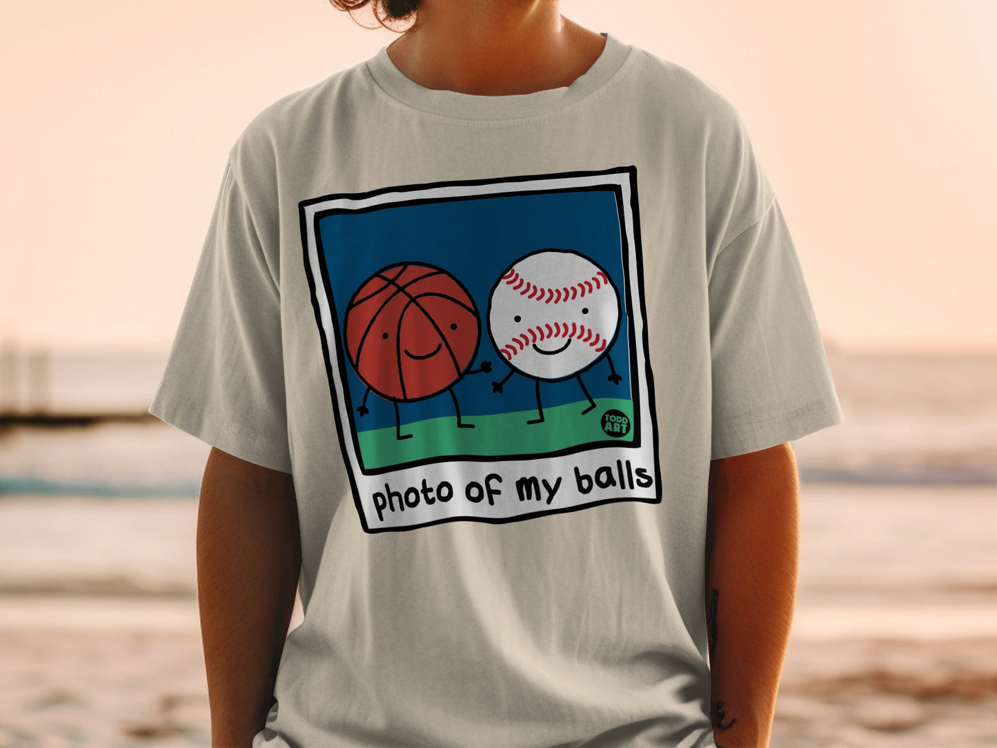 Cartoon basketball and baseball holding hands with text "photo of my balls".