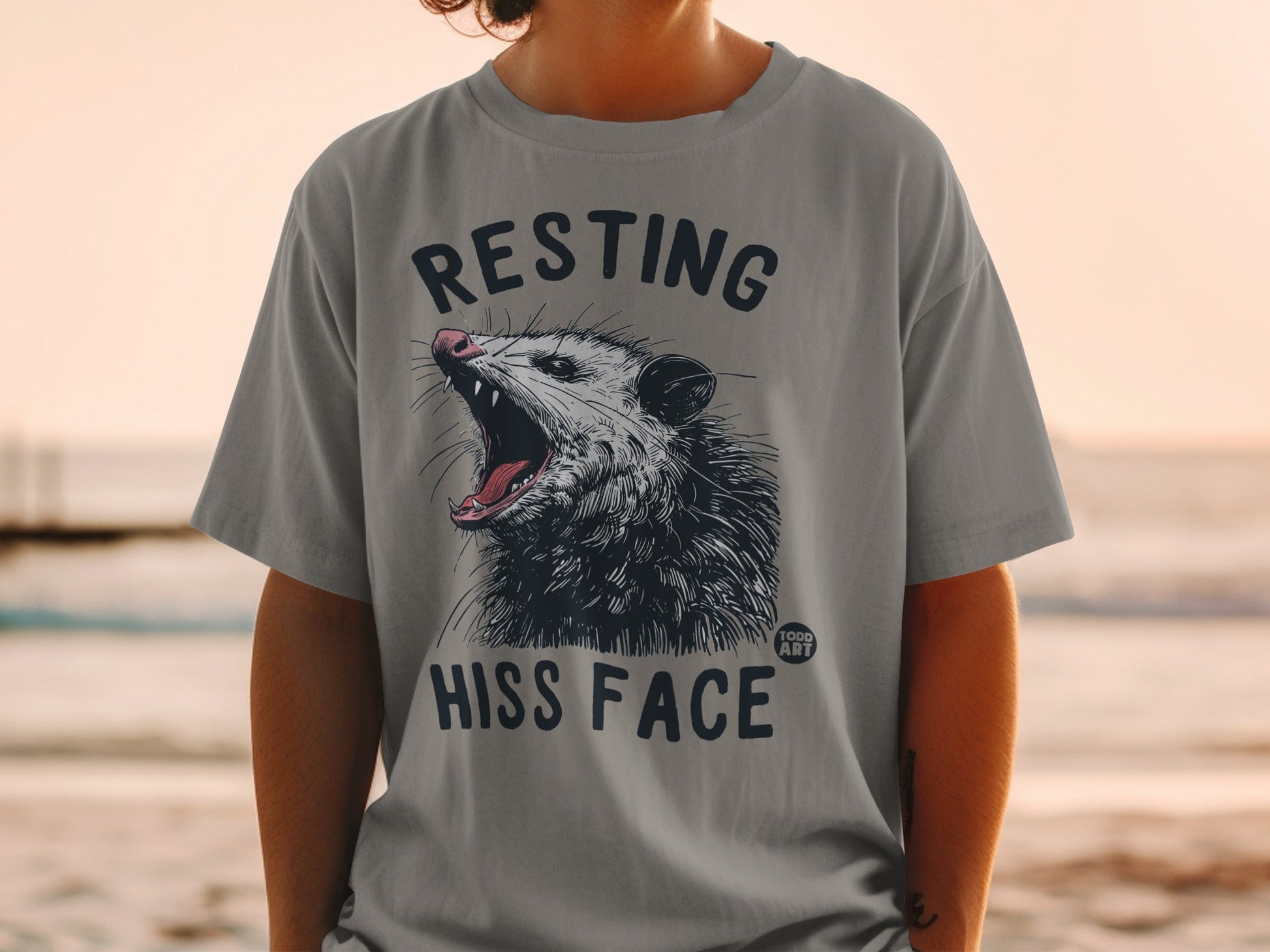 T-shirt with opossum roaring "RESTING HISS FACE" text.