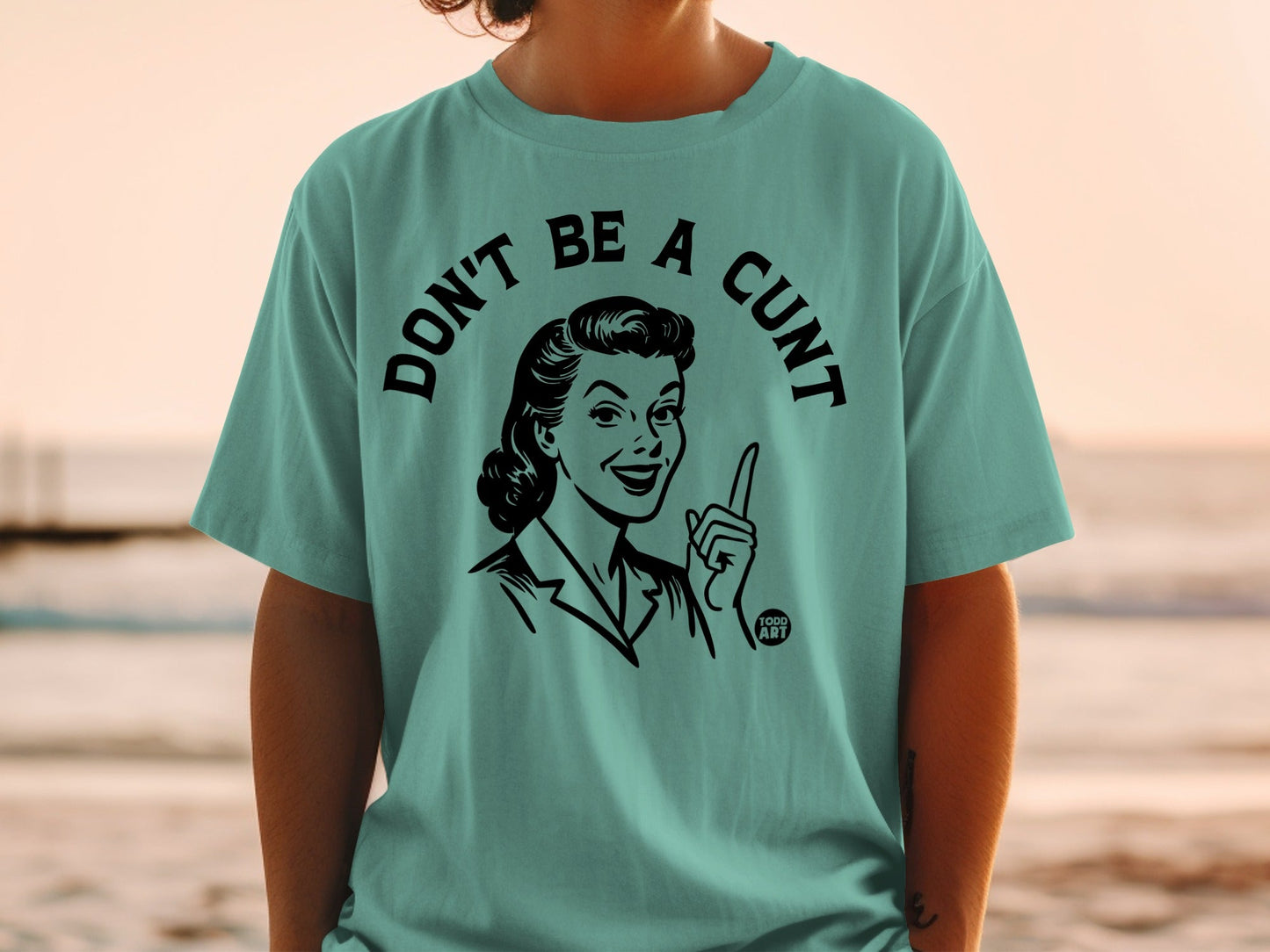 Teal t-shirt with vintage illustration and "DON'T BE A CUNT" text.
