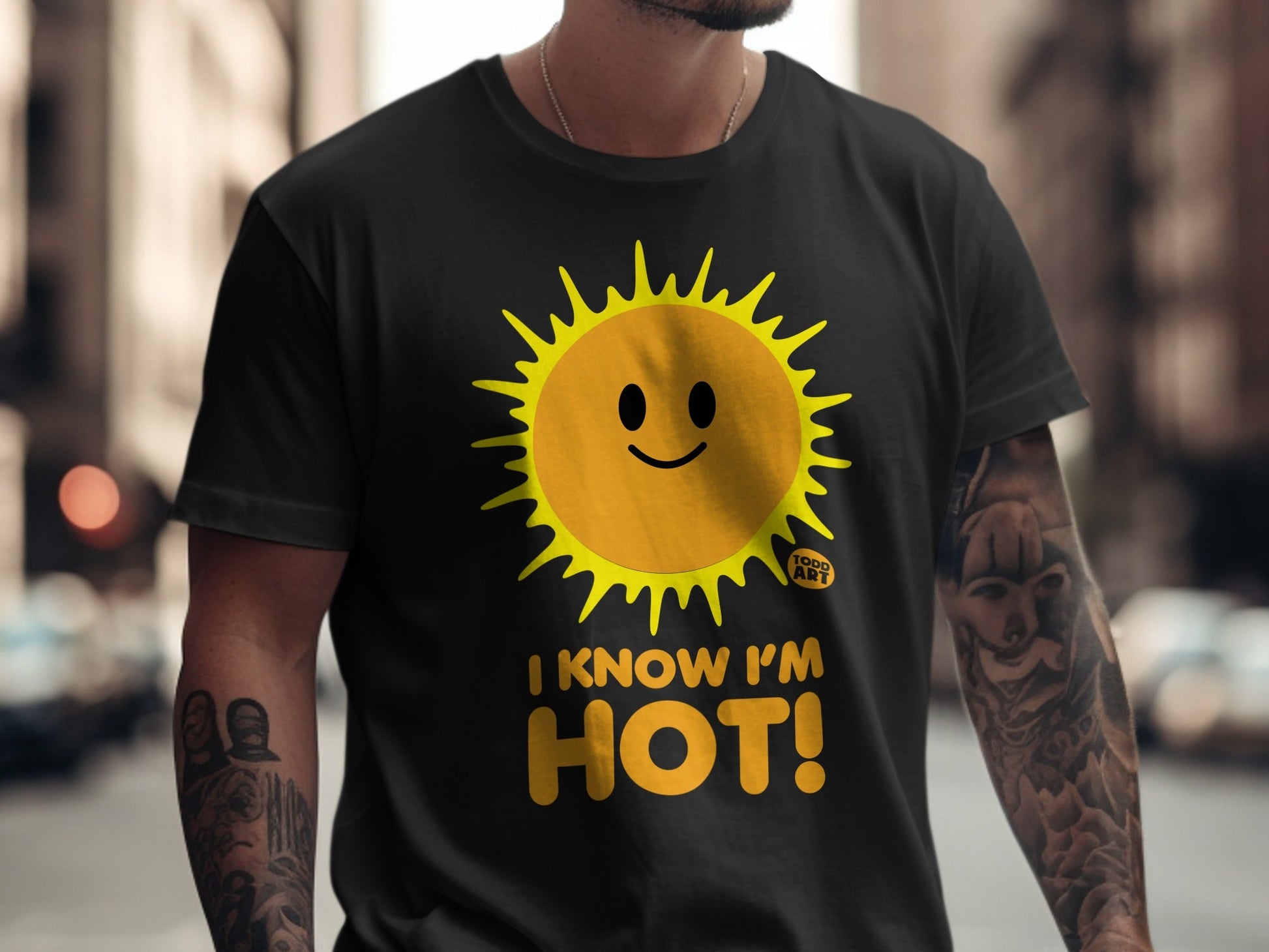 Black t-shirt with a smiling yellow sun graphic and the text "I KNOW I'M HOT!"