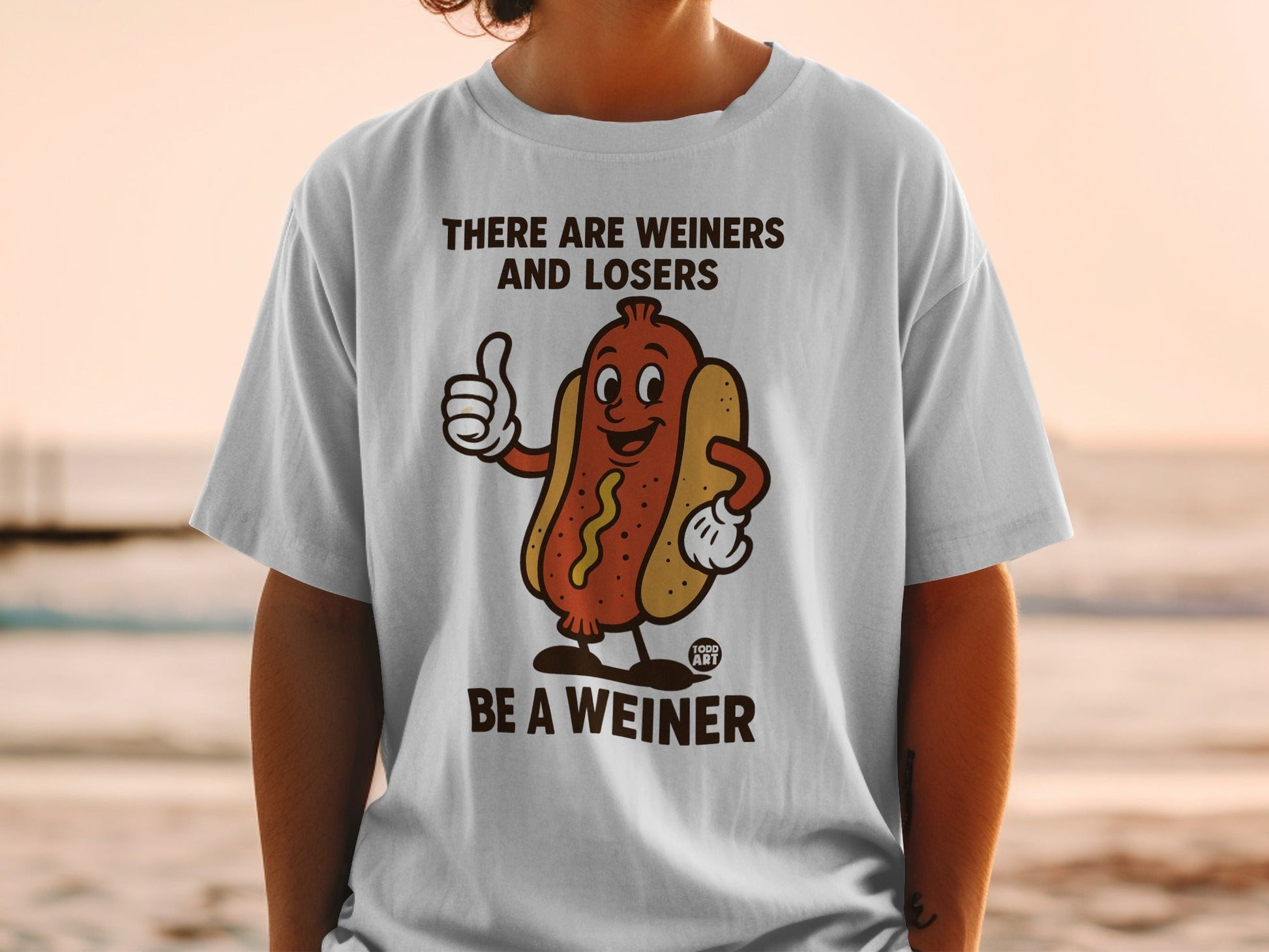 T-shirt with hot dog graphic and text "THERE ARE WEINERS AND LOSERS BE A WEINER".