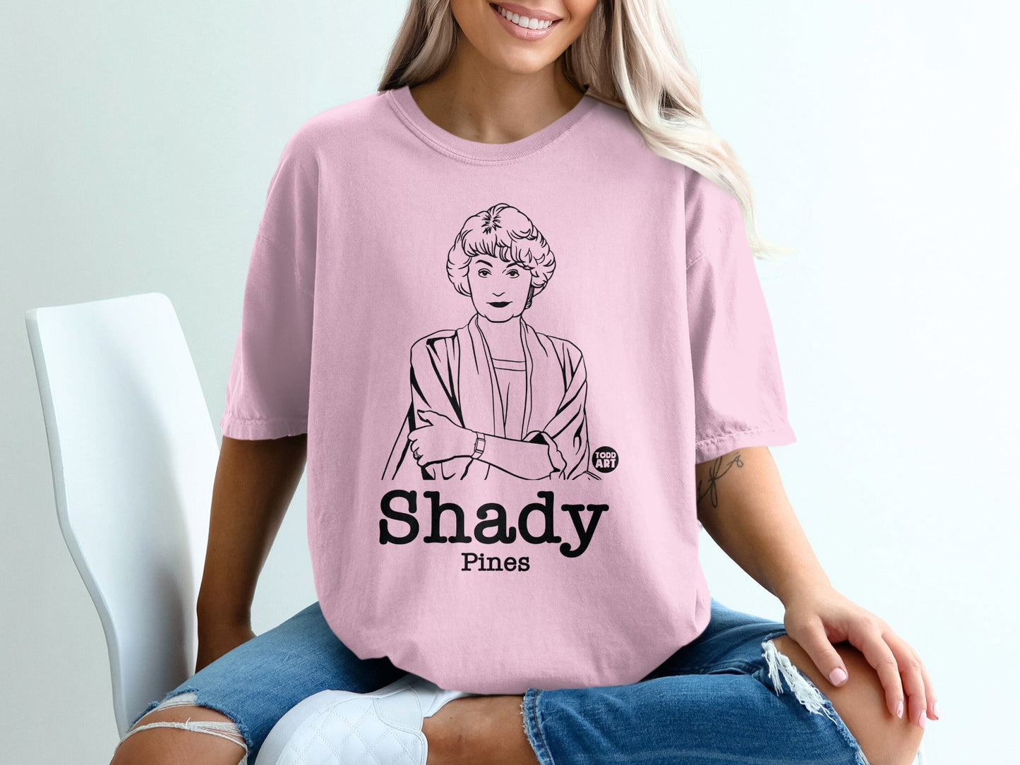 Pink t-shirt with line art of Blanche Devereaux from The Golden Girls and "Shady Pines" text.