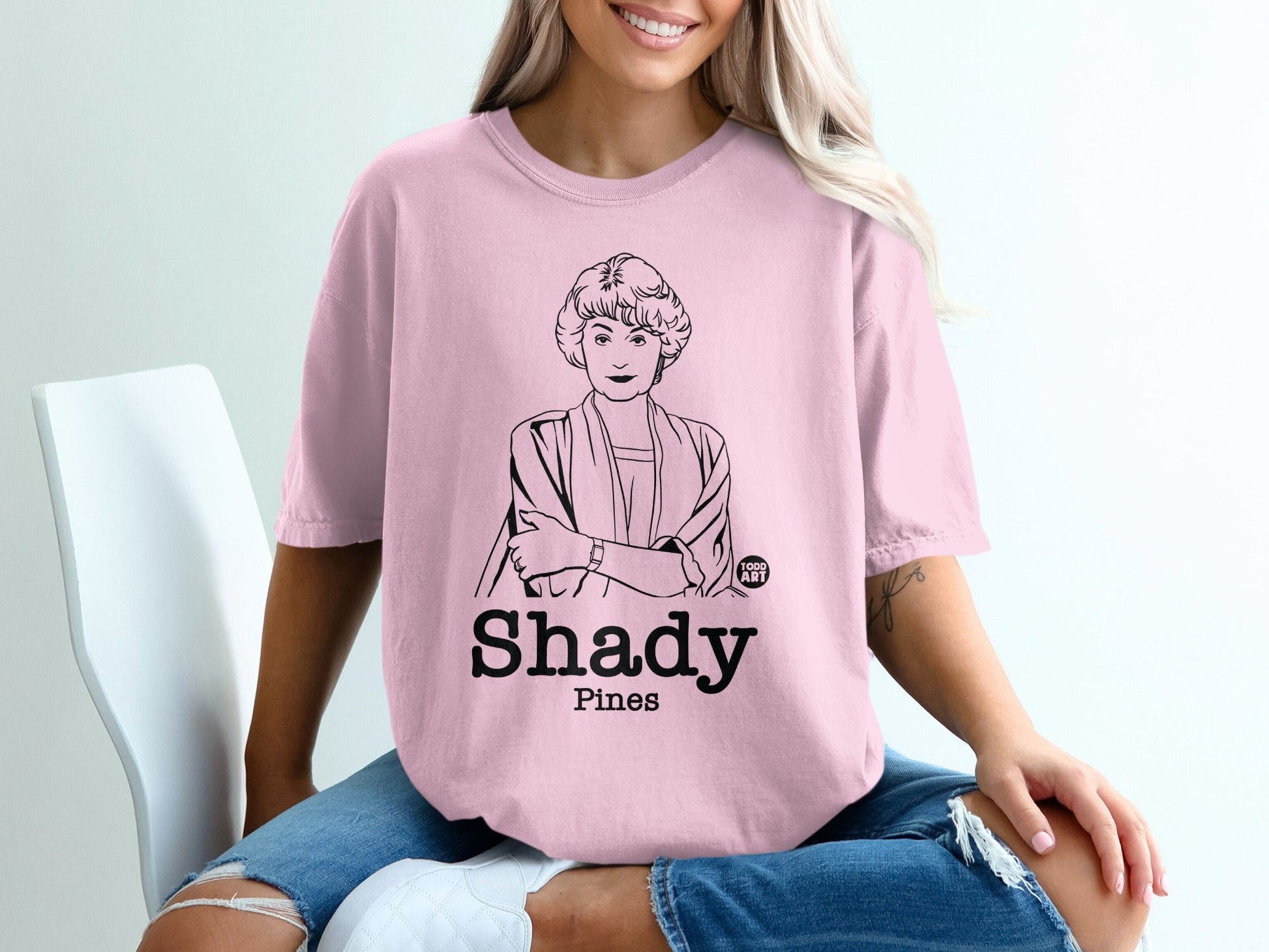 Pink t-shirt with line art of Blanche Devereaux from The Golden Girls and "Shady Pines" text.