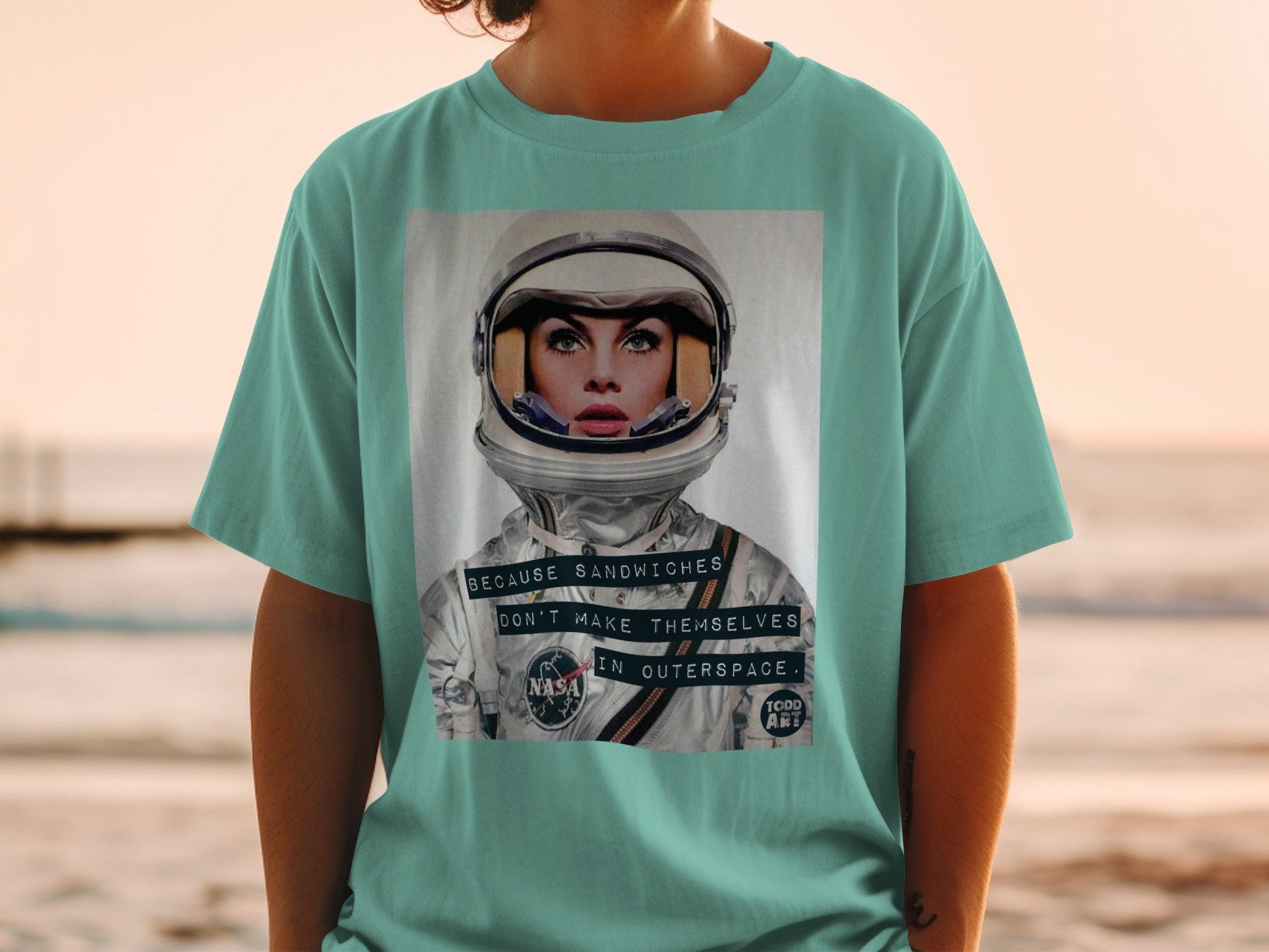 T-shirt featuring a woman in an astronaut helmet with text about outer space.