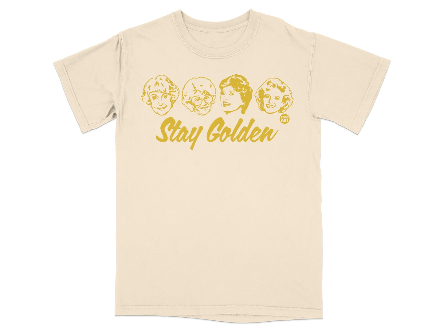 Cream t-shirt with "Stay Golden" and four cartoon faces of The Golden Girls.