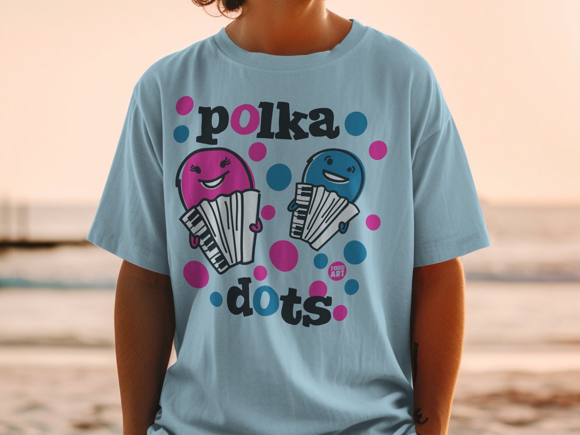 Light blue t-shirt with cartoon accordions and "polka dots" text.