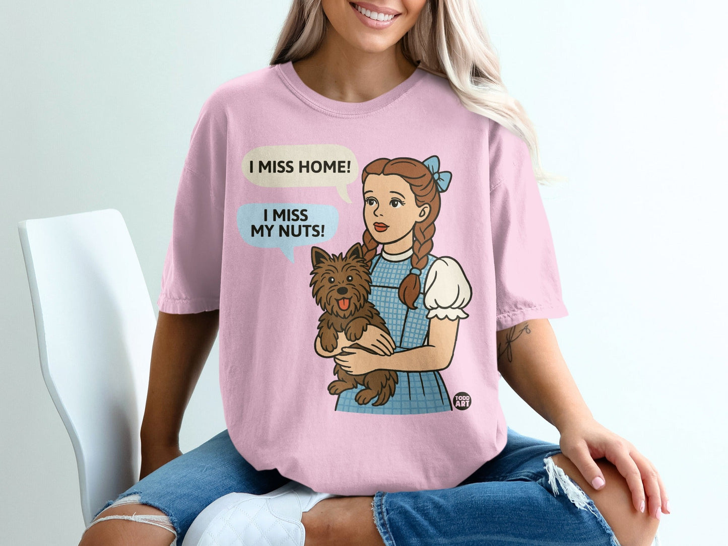 Dorothy holding Toto, with speech bubbles saying "I miss home!" and "I miss my nuts!".