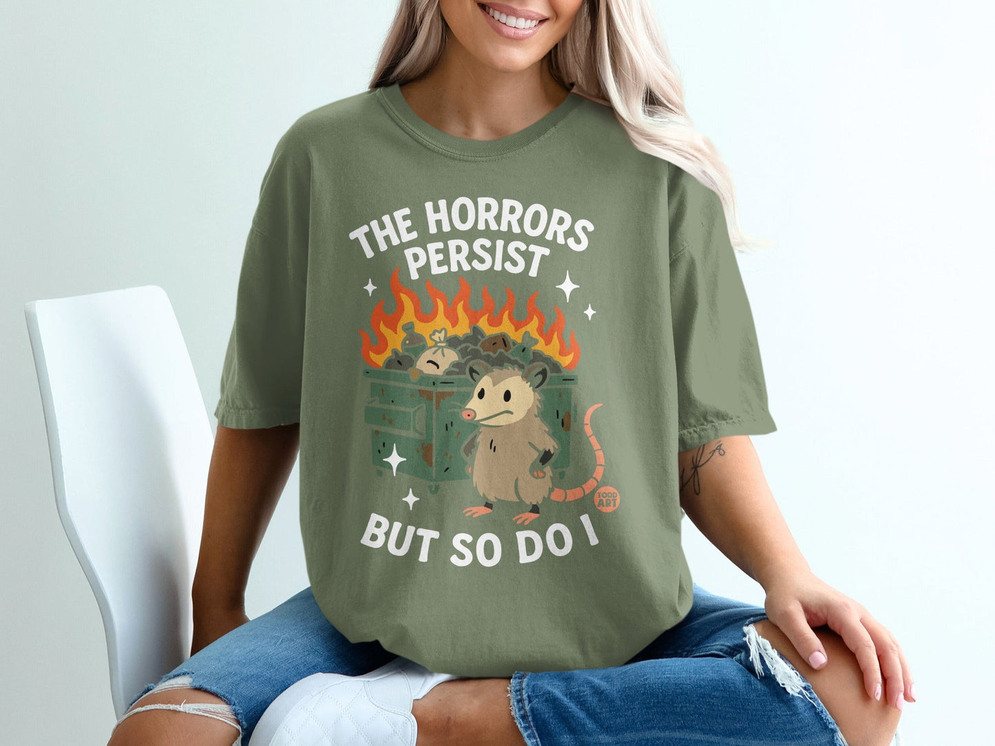 Opossum in trash fire with text "The horrors persist but so do I".