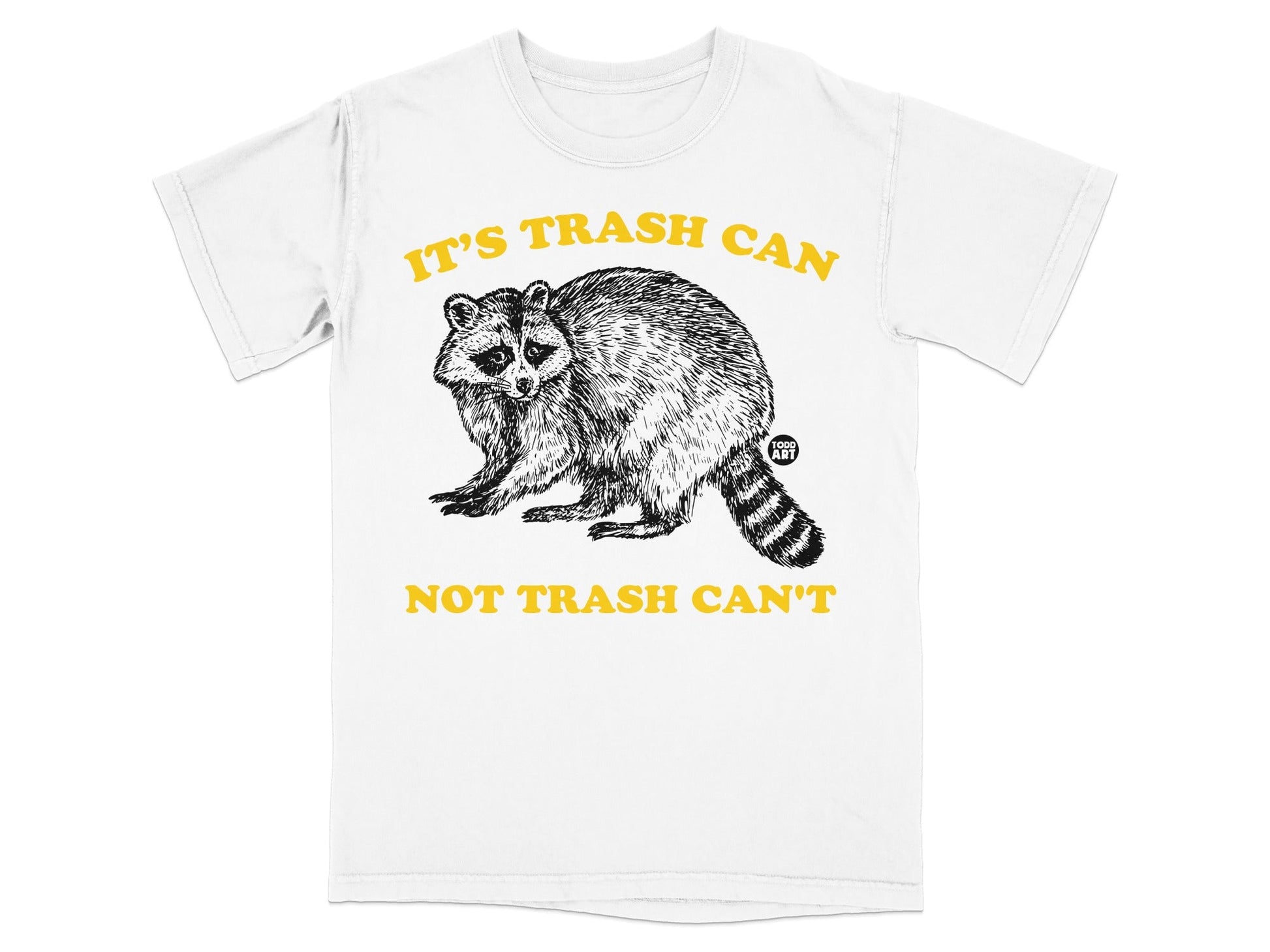 White t-shirt with a raccoon graphic and yellow text that reads "IT'S TRASH CAN NOT TRASH CAN'T".