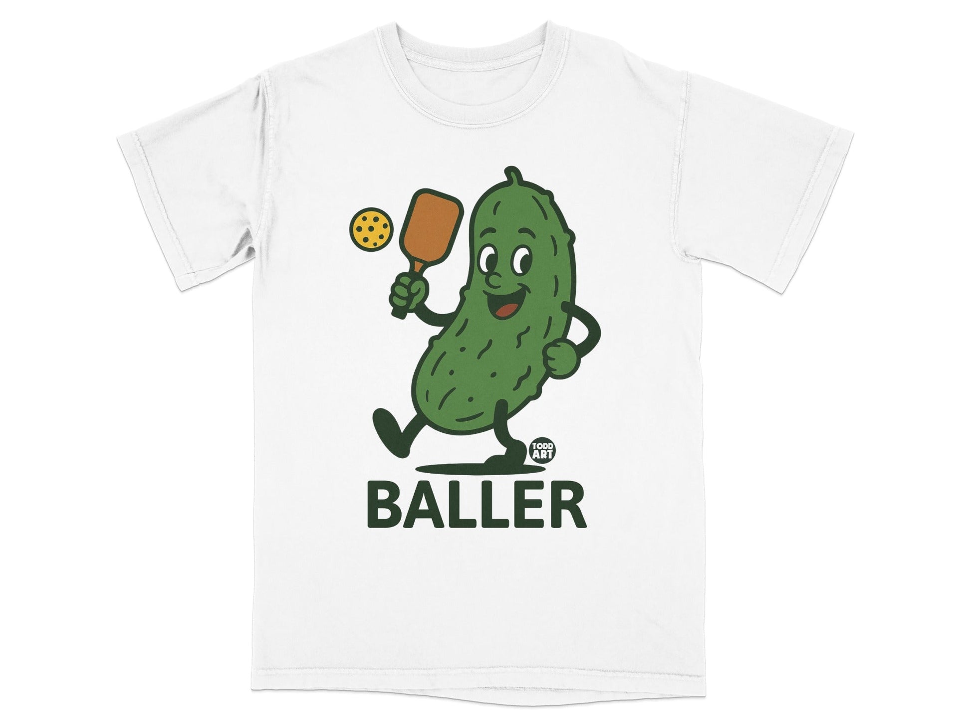 T-shirt with cartoon pickle playing pickleball, "Food Art Baller" text.