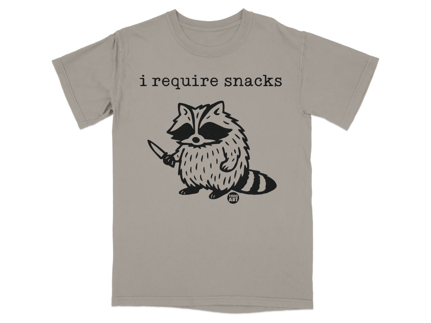 T-shirt with a raccoon holding a knife and the text "i require snacks".