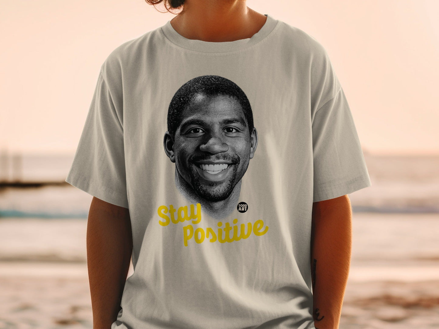T-shirt with Magic Johnson's portrait and "Stay Positive" text.