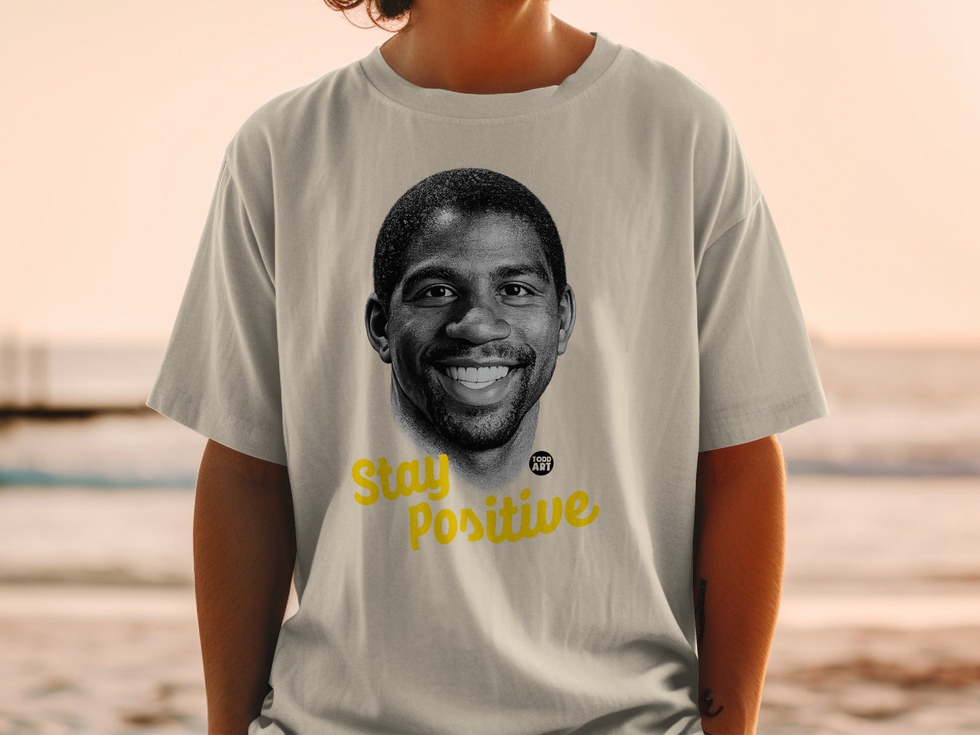 T-shirt with Magic Johnson's portrait and "Stay Positive" text.