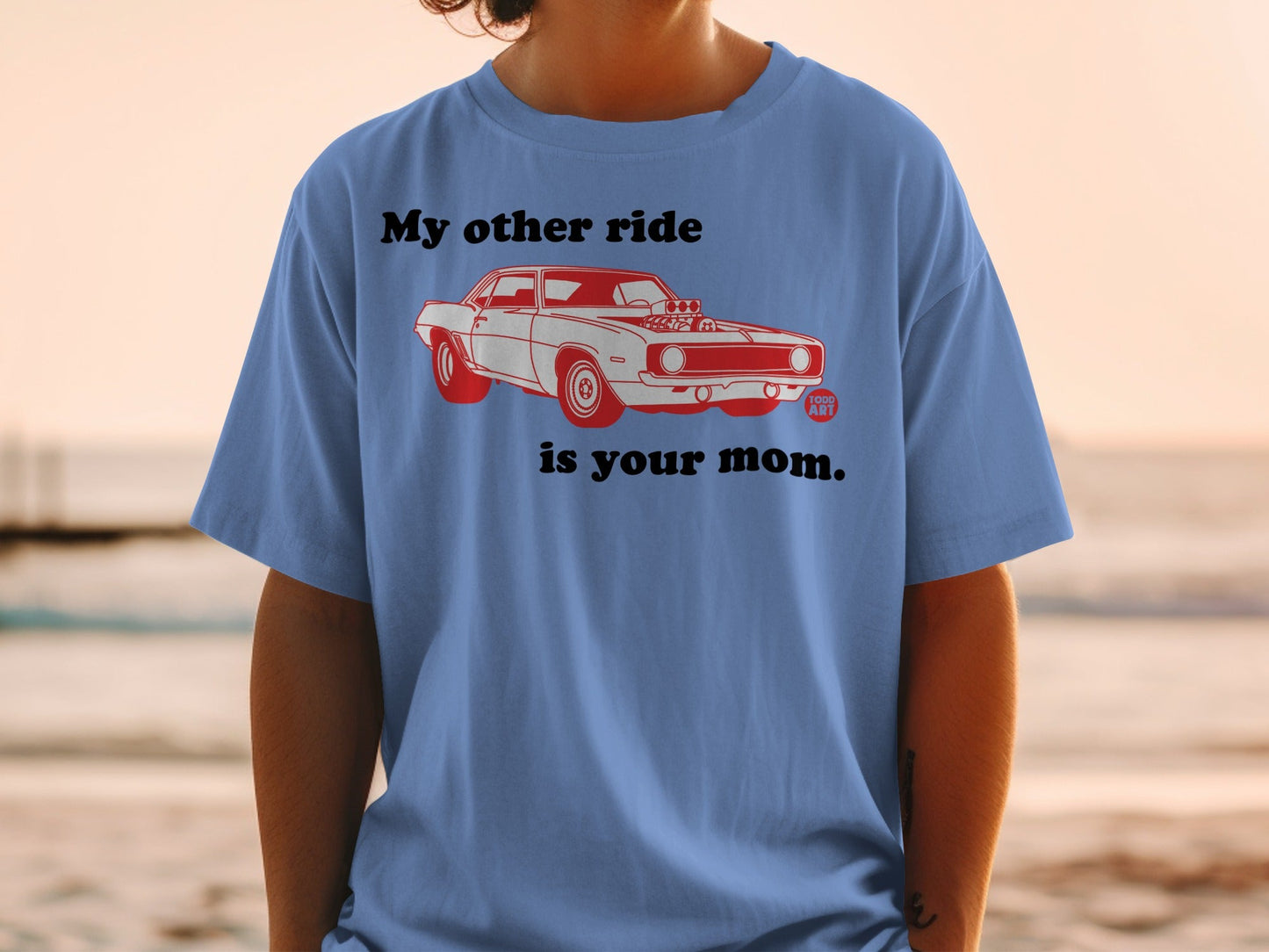 Blue t-shirt with graphic of a red classic car and text "My other ride is your mom."
