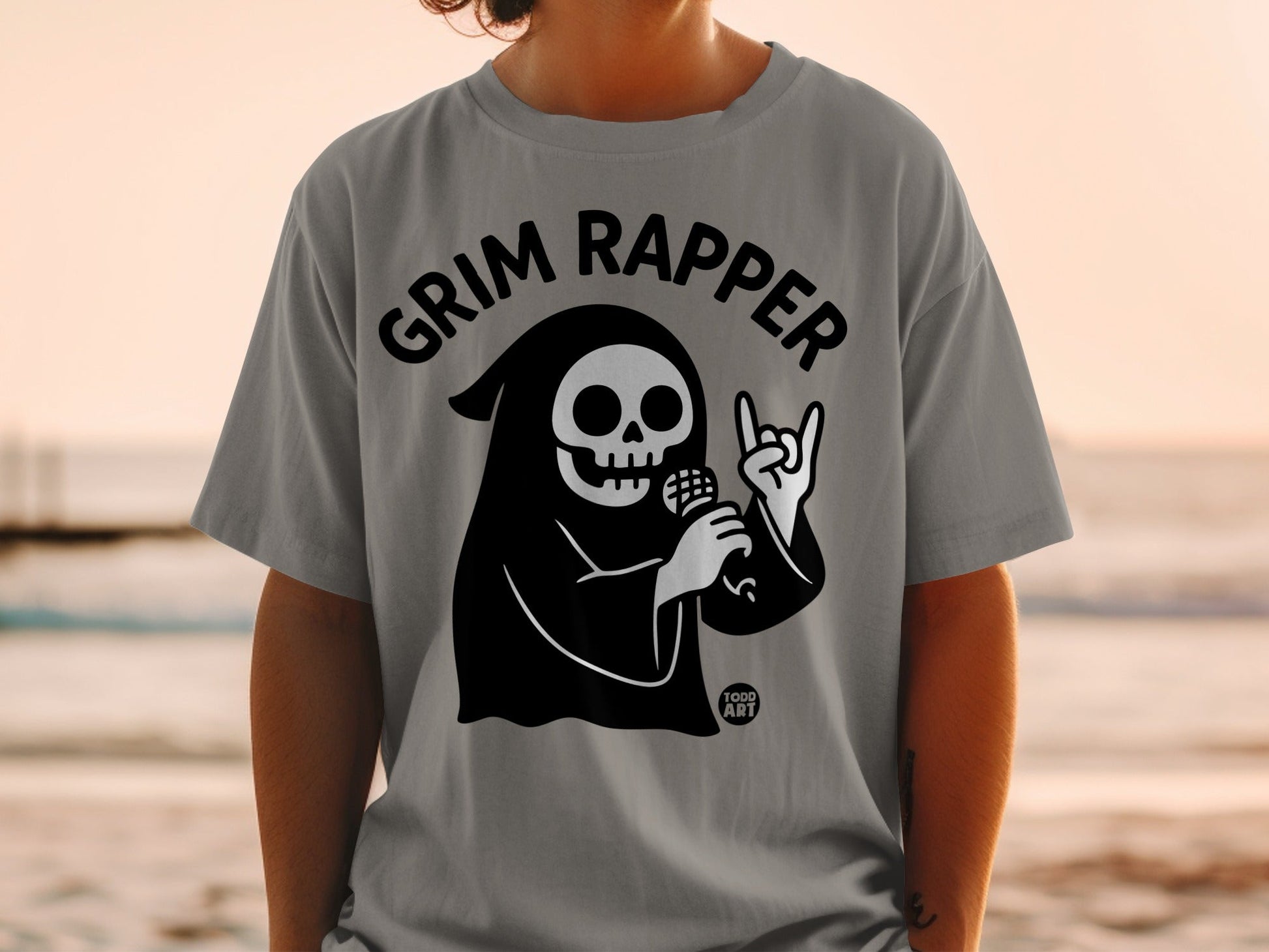Grim Reaper with microphone and rock on hand graphic on gray t-shirt.