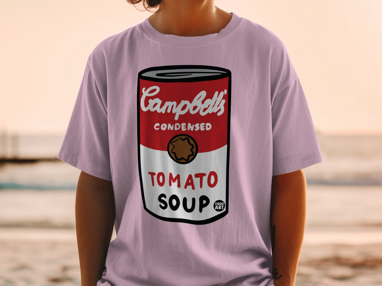 Campbell's Condensed Tomato Soup can graphic on a pink t-shirt.