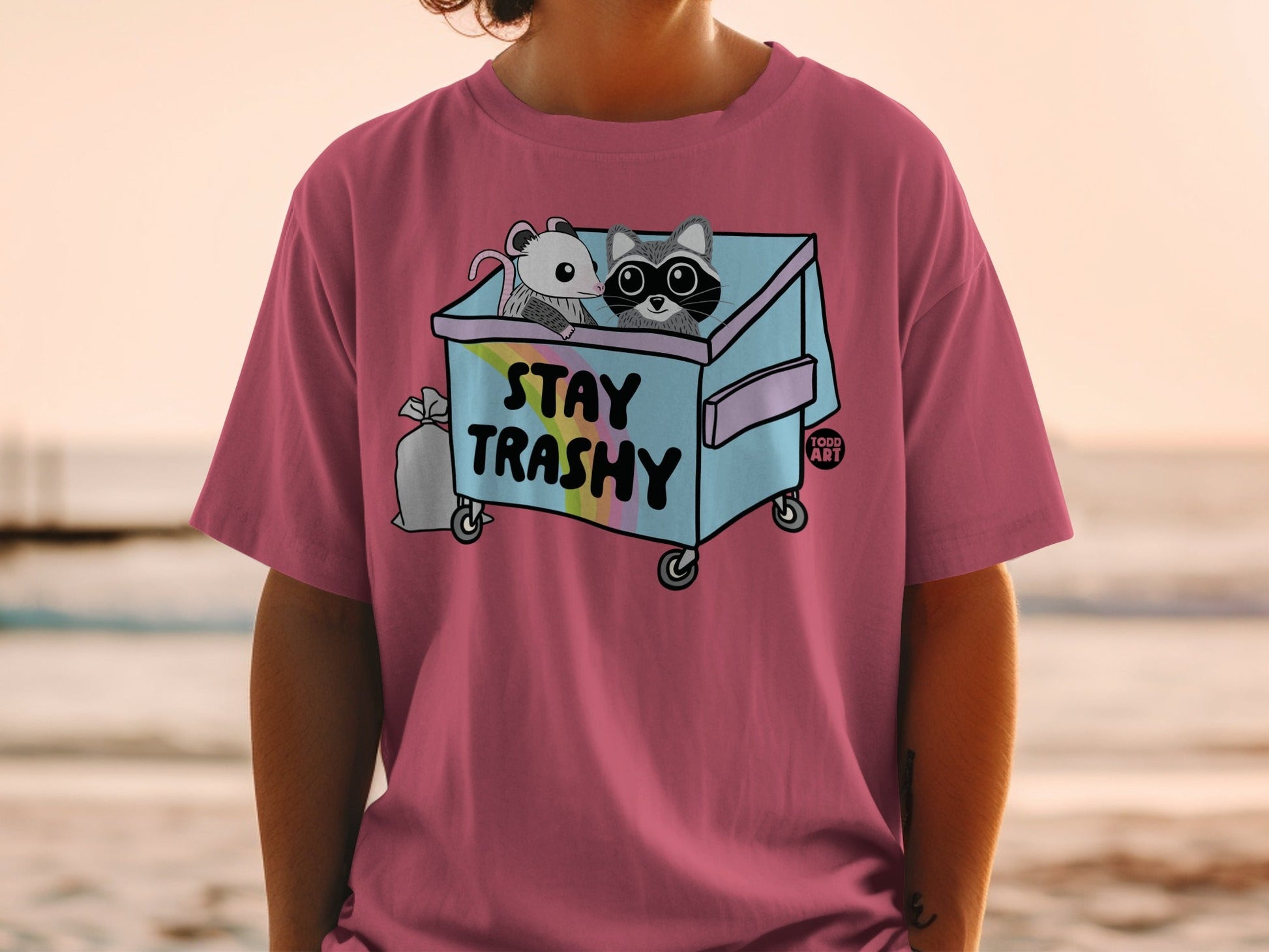 Two cartoon animals in a trash can, text "STAY TRASHY".