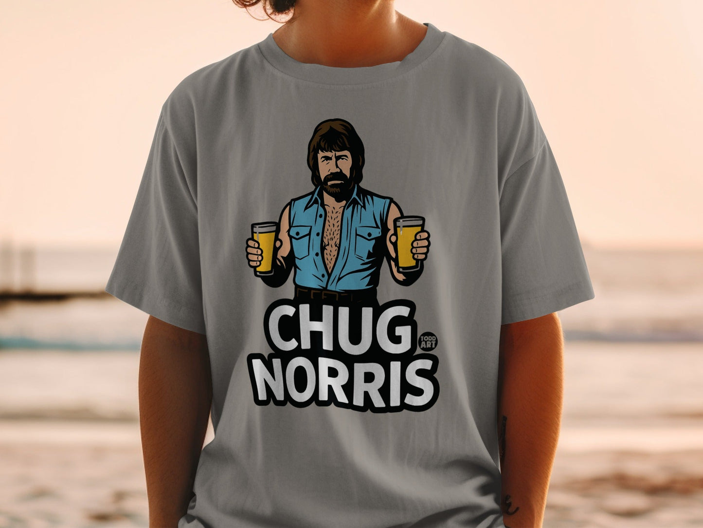 Gray t-shirt featuring Chuck Norris holding two beers, text reads "CHUG NORRIS".