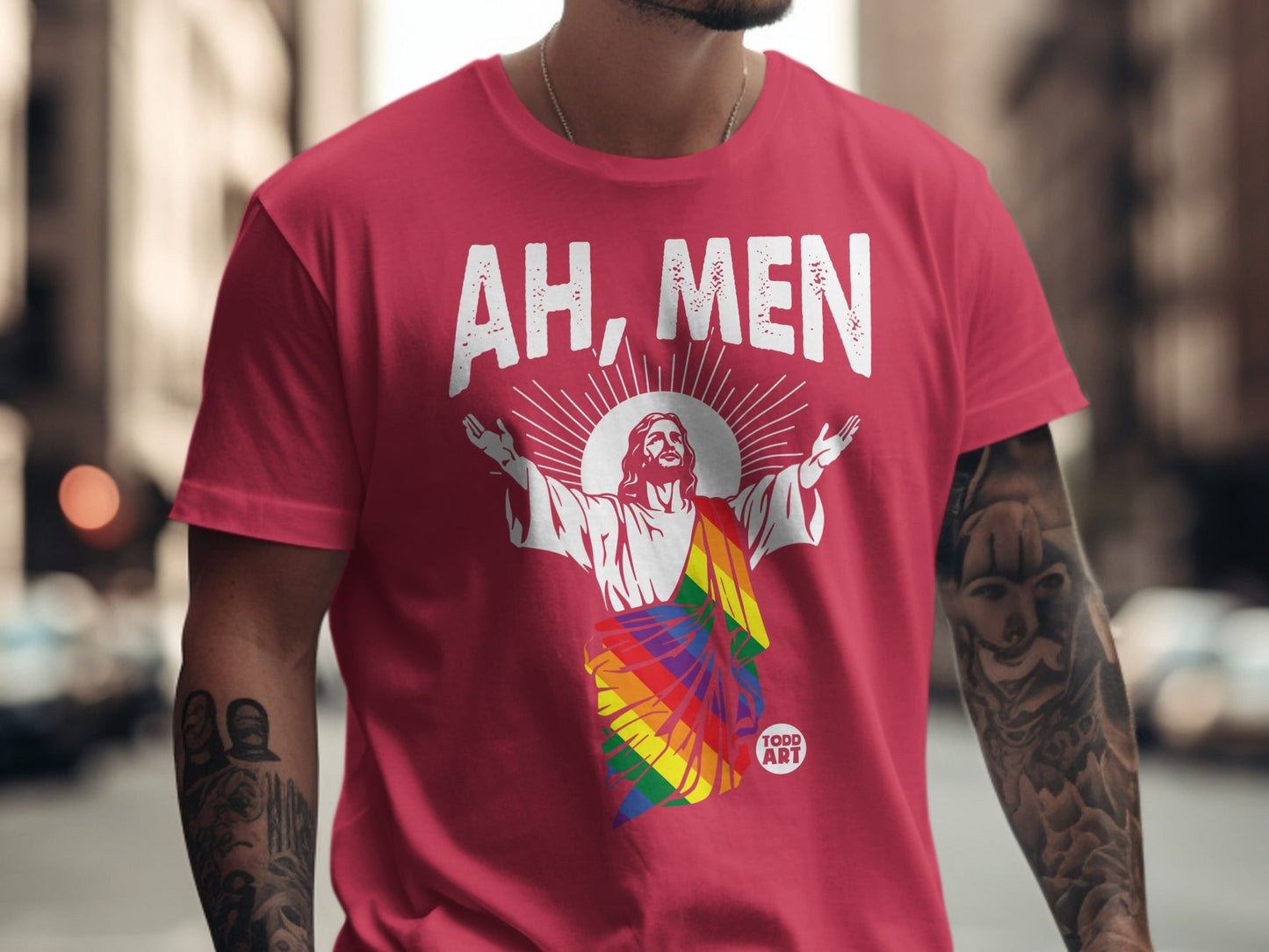Red t-shirt with "AH, MEN" above a rainbow Jesus graphic.